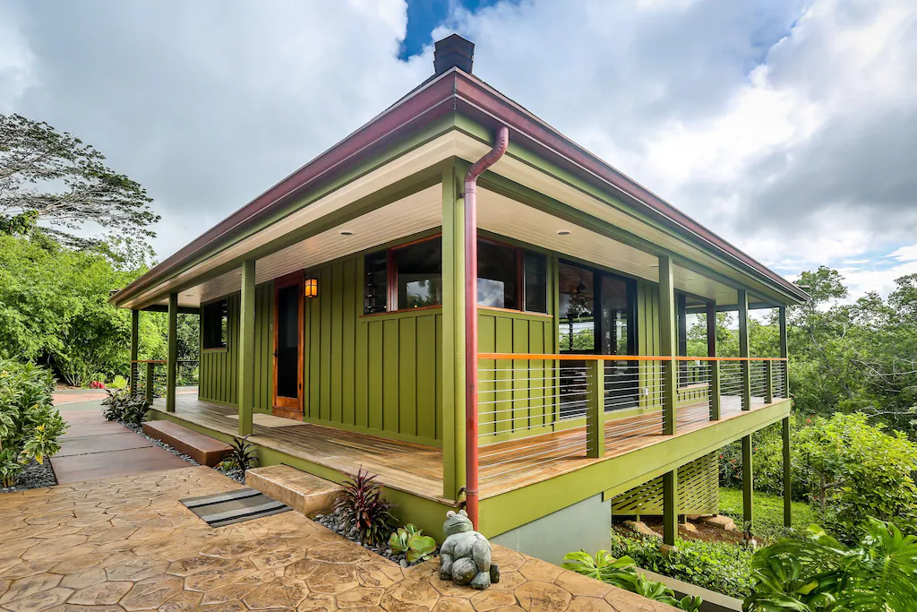 Image of a green North Shore Kauai vacation rental home surrounded by lush greenery