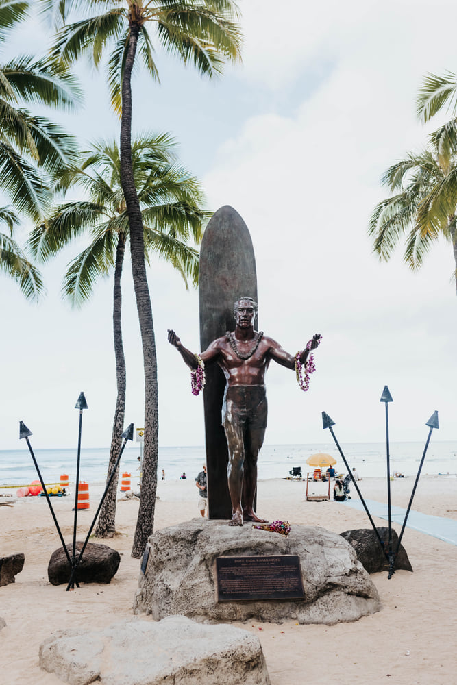 Image of a statue of Duke Kahanamoku, a world-famous surfer, on the beach at Waikiki.