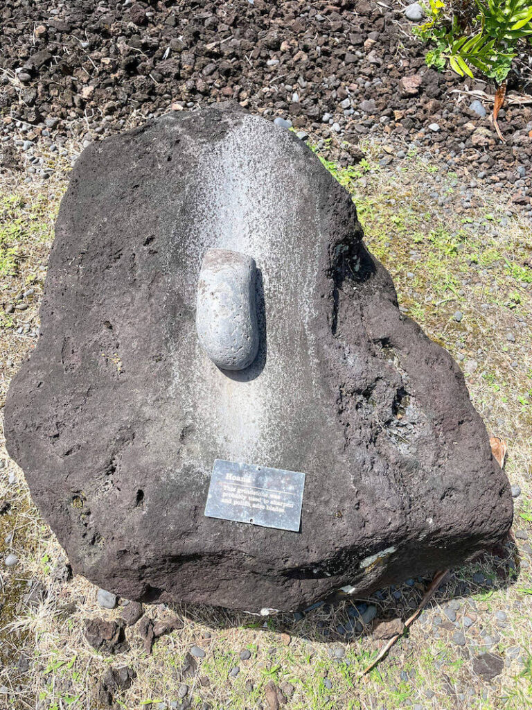 Image of a large rock with a smaller, smooth rock on top.