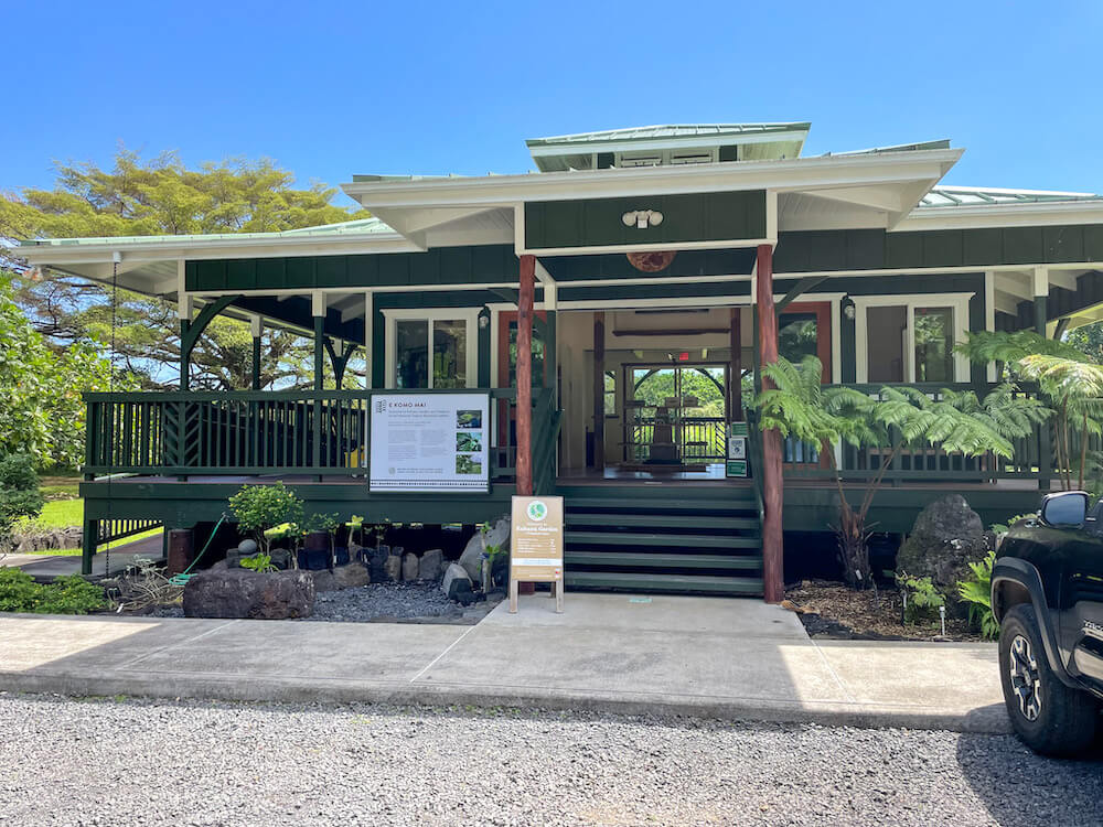 Image of a green and white building that's Hawaiian plantation style.