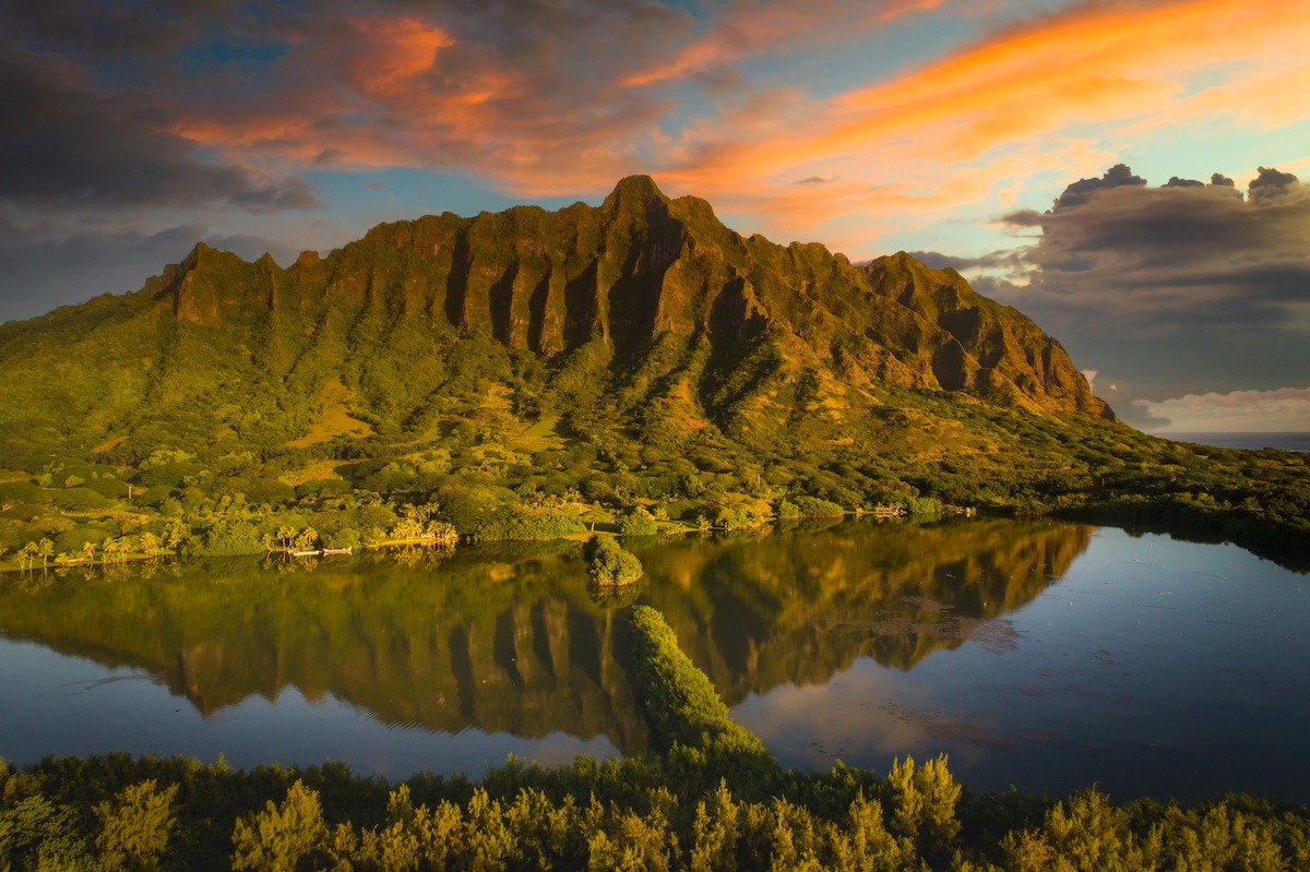 Find out the best Oahu Instagram spots recommended by top Hawaii blog Hawaii Travel with Kids. Image of the Kualoa Mountains at sunset.
