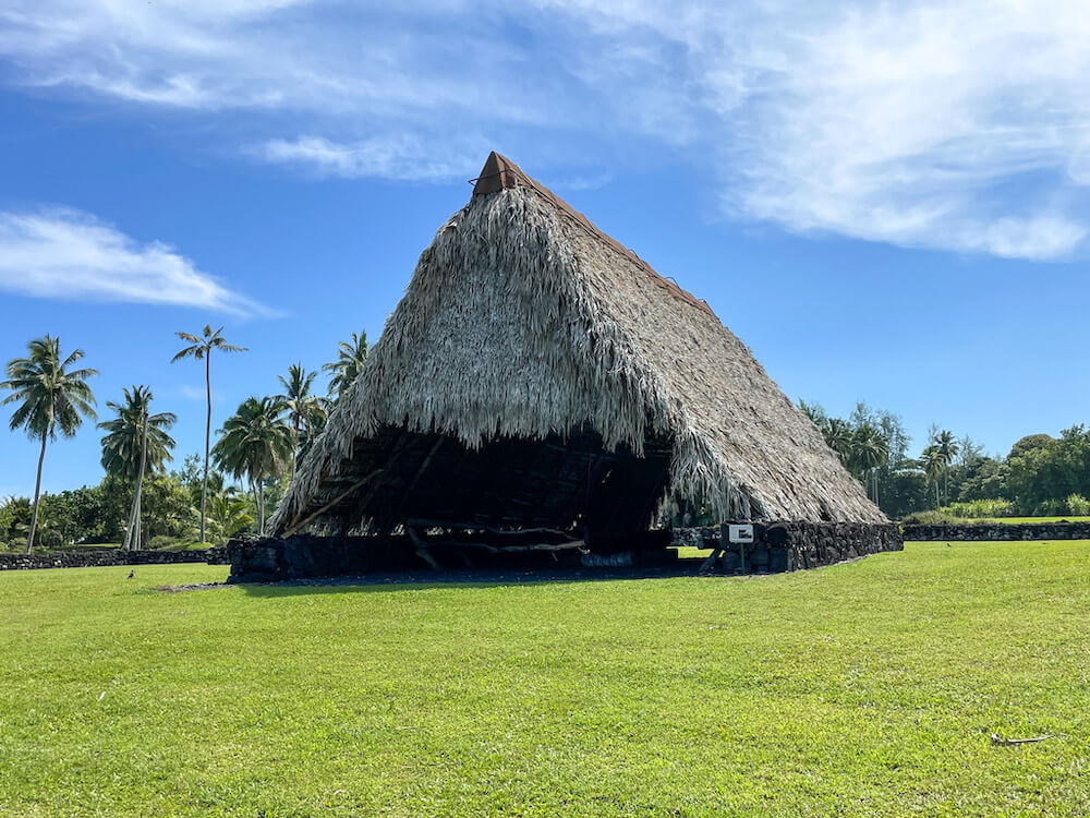 Image of a huge thatched roof A-frame building at a Maui botanical garden.