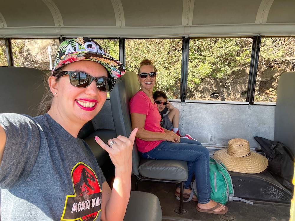 Image of a grandma, mom, and son inside a bus