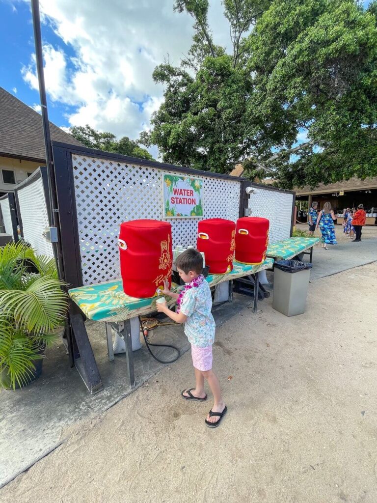 Image of a boy getting water out of a water jug.