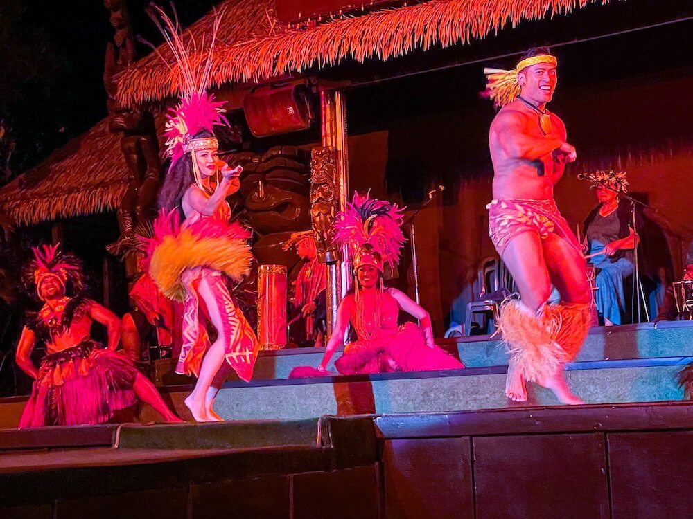 Image of a man and woman dancing Tahitian at a luau in Oahu