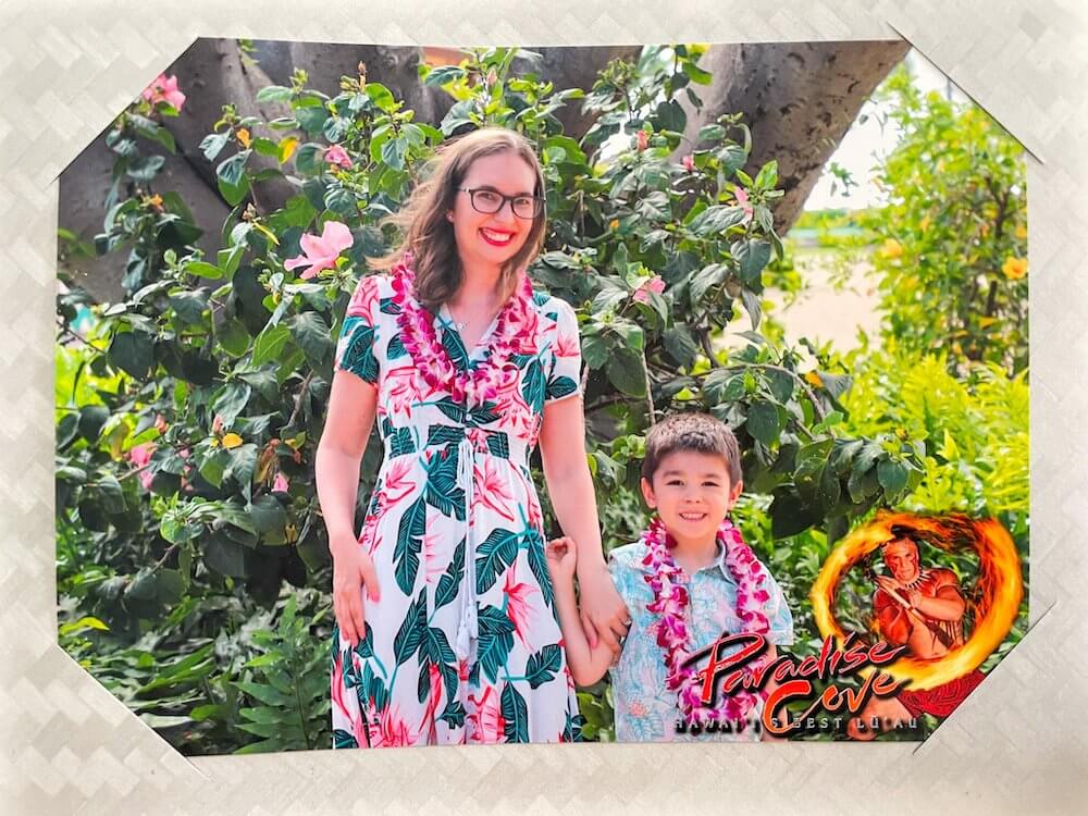 Image of a mom and son wearing Aloha wear and posing for a photo at Paradise Cove luau in Ko Olina.