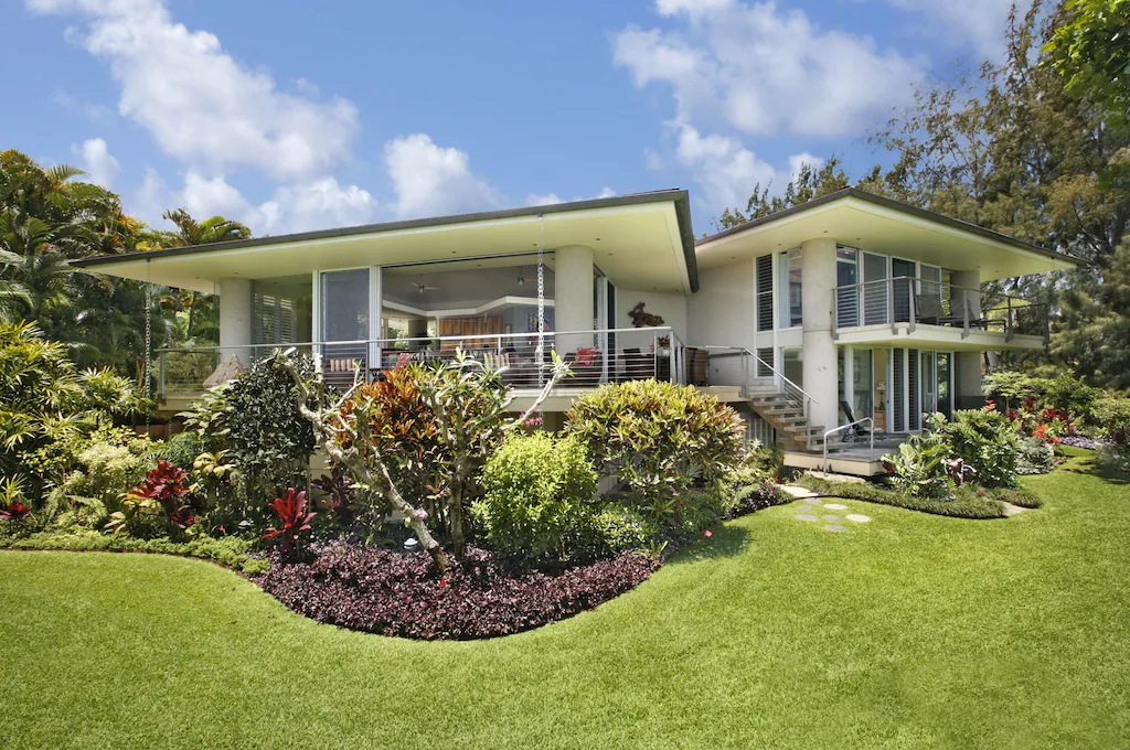 Image of a white two story home with a grassy lawn