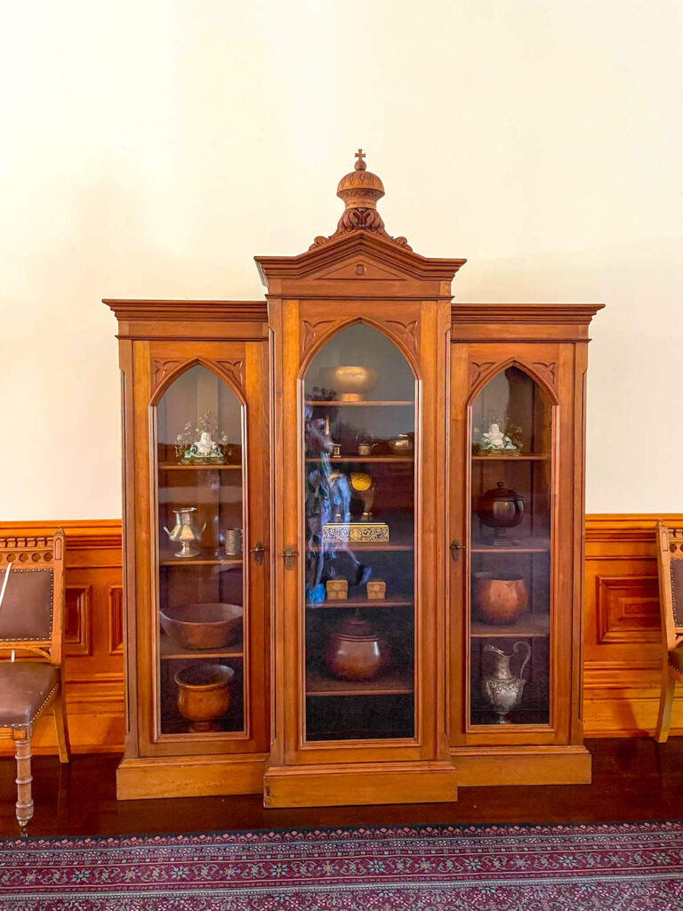 Image of a wooden cabinet filled with knick knacks.