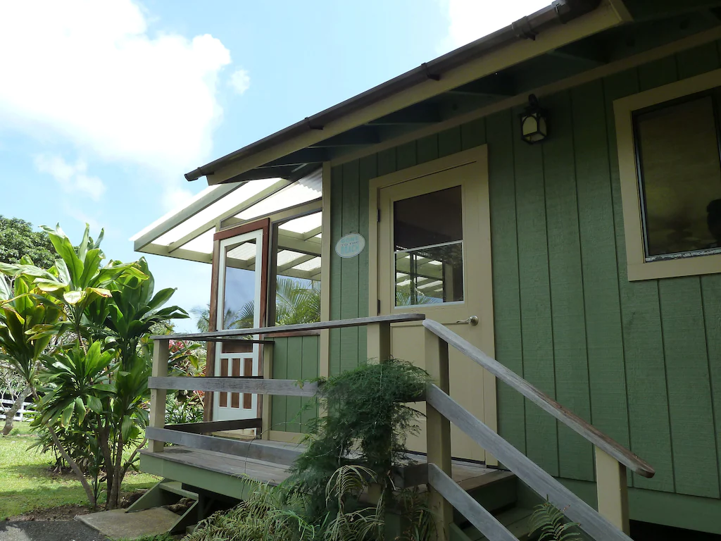 Image of a green plantation style home in Hana