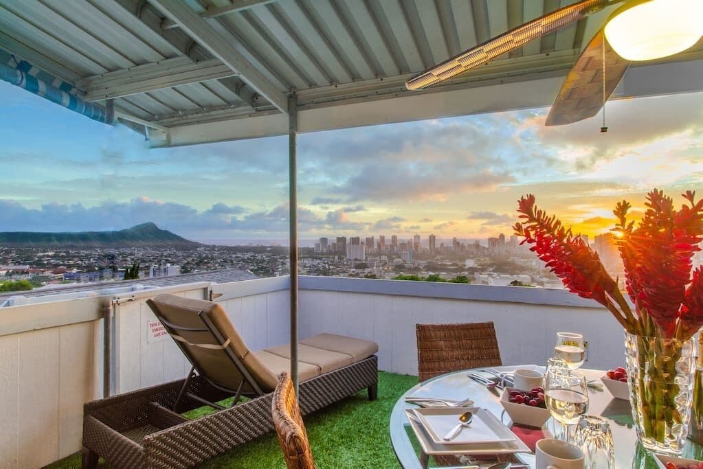 Image of an outdoor table on a deck that overlooks Waikiki and Diamond Head