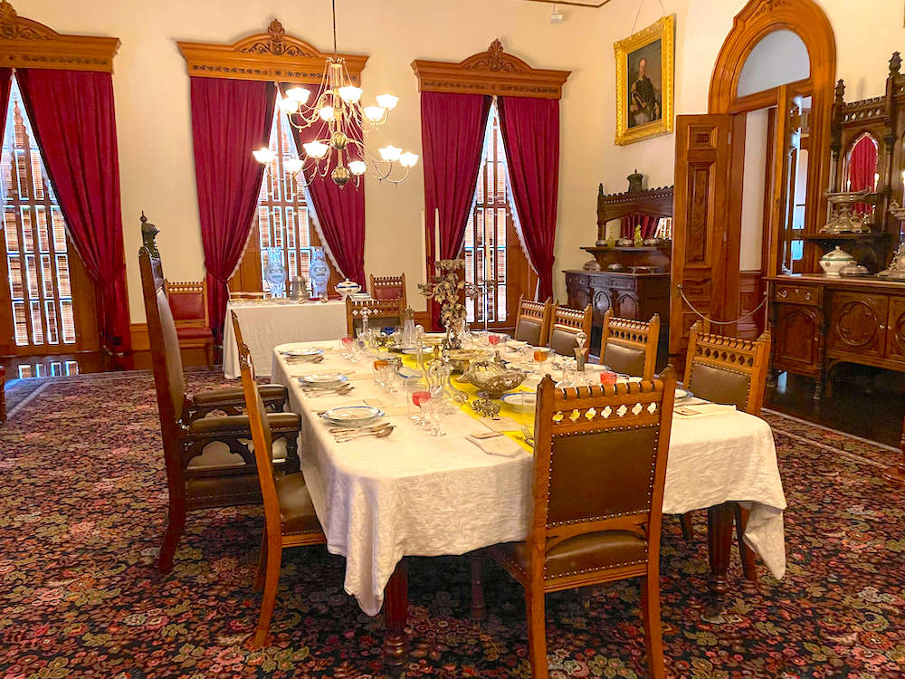 Image of a royal dining room including a throne chair for the king.