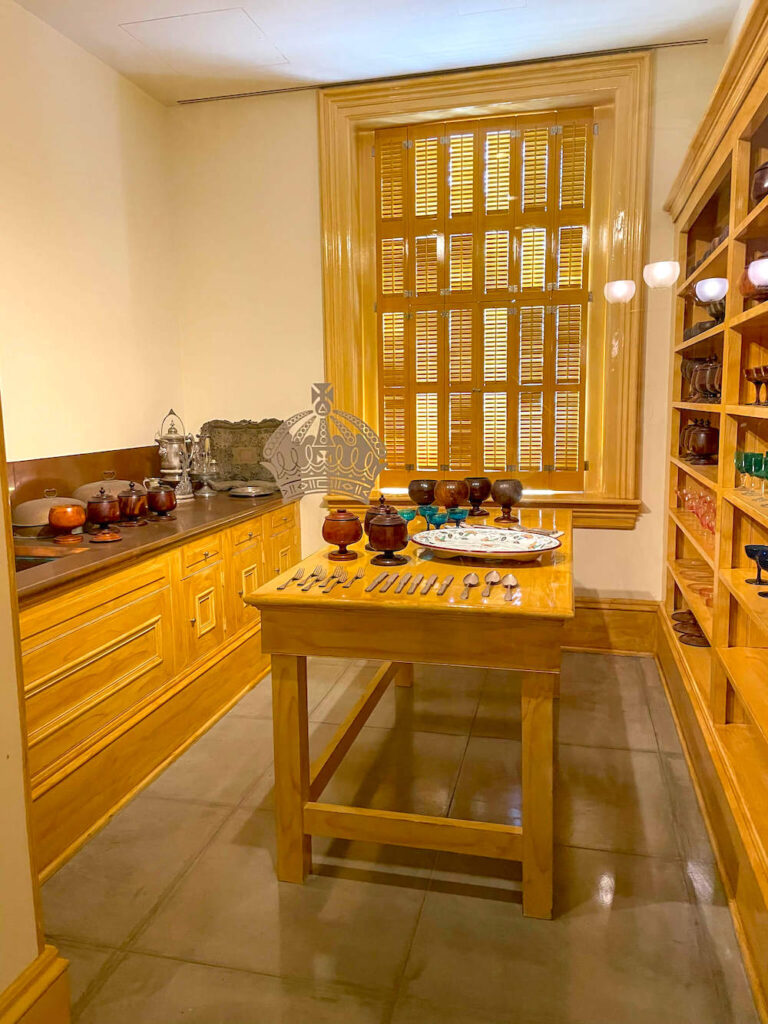 Image of a wooden kitchen with lots of cups on shelves.