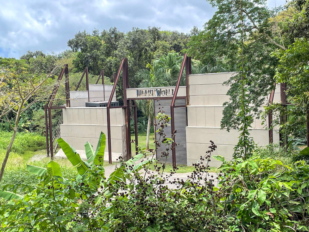 Image of a huge Jurassic World building in the middle of the jungle