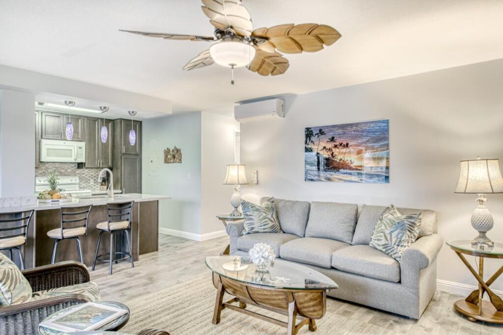 Image of a condo living room with a white/grey theme