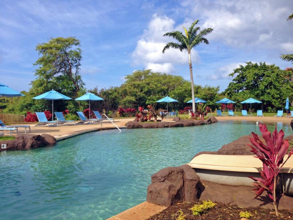 Image of a pool surrounded by deck chairs in Hawaii