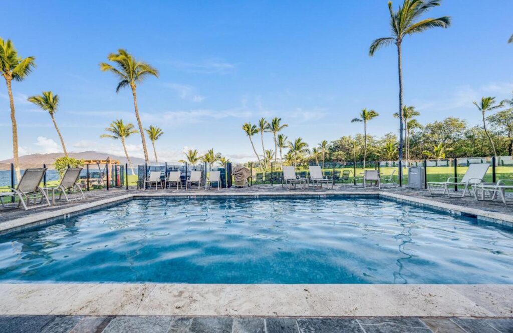 Image of a rectangular pool surrounded by pool furniture