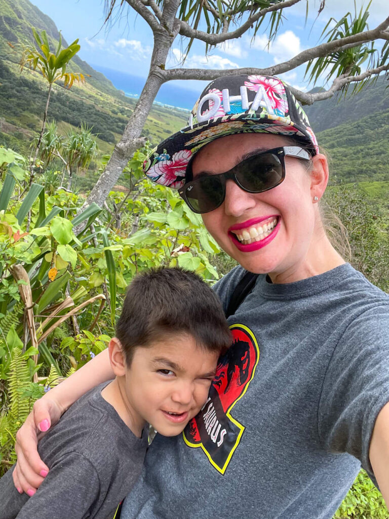 Mom and son taking a selfie at a scenic viewpoint at Kualoa Ranch