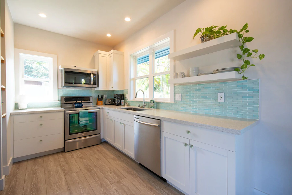 Image of a white and seafoam green kitchen in a cottage on Maui