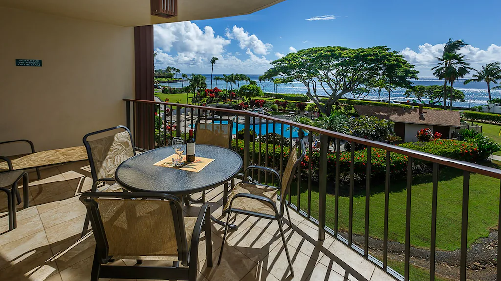 Image of a deck that overlooks a pool and the Pacific Ocean