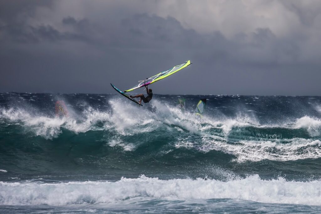Image of someone windsurfing on rough water in Maui