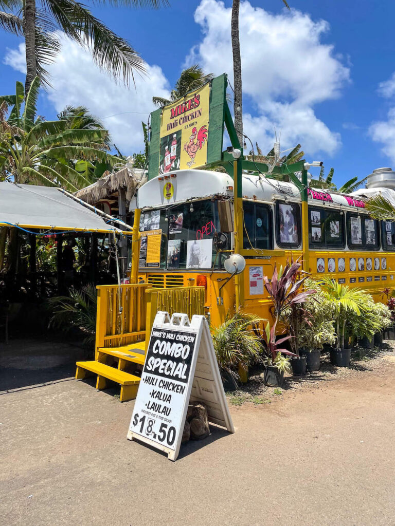 Image of a yellow food truck for Mike's Huli Chicken in North Shore Oahu