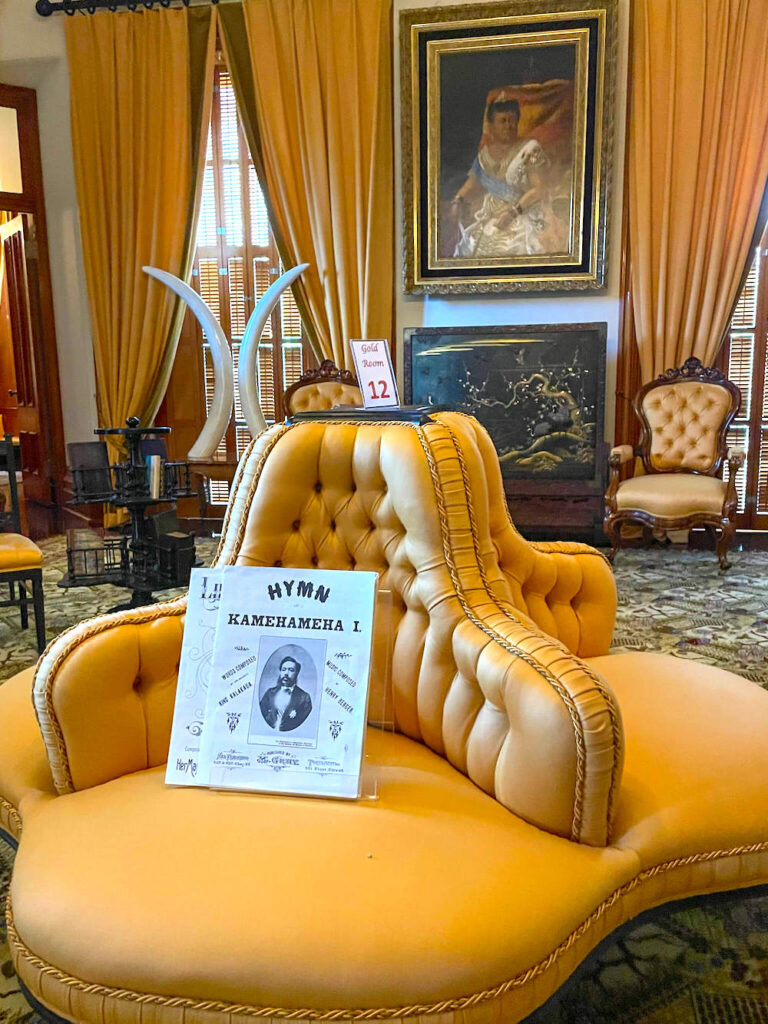 Image of a unique yellow chair with sheet music on it.