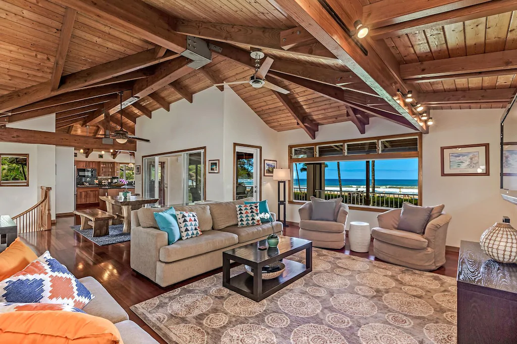 Image of a living room with high ceilings and a view of the ocean