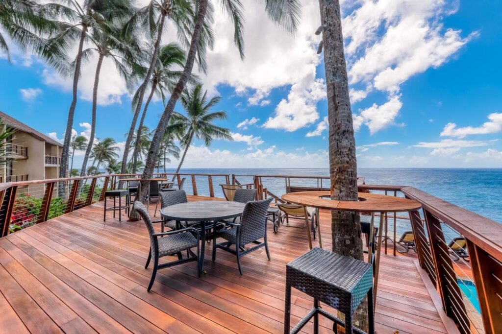 Image of deck chairs on a massive deck overlooking the ocean