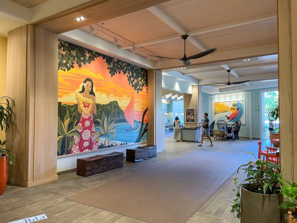 Check out this honest Queen Kapiolani Hotel review by top Hawaii blog Hawaii Travel with Kids! Image of a Waikiki hotel lobby with Hawaiian artwork