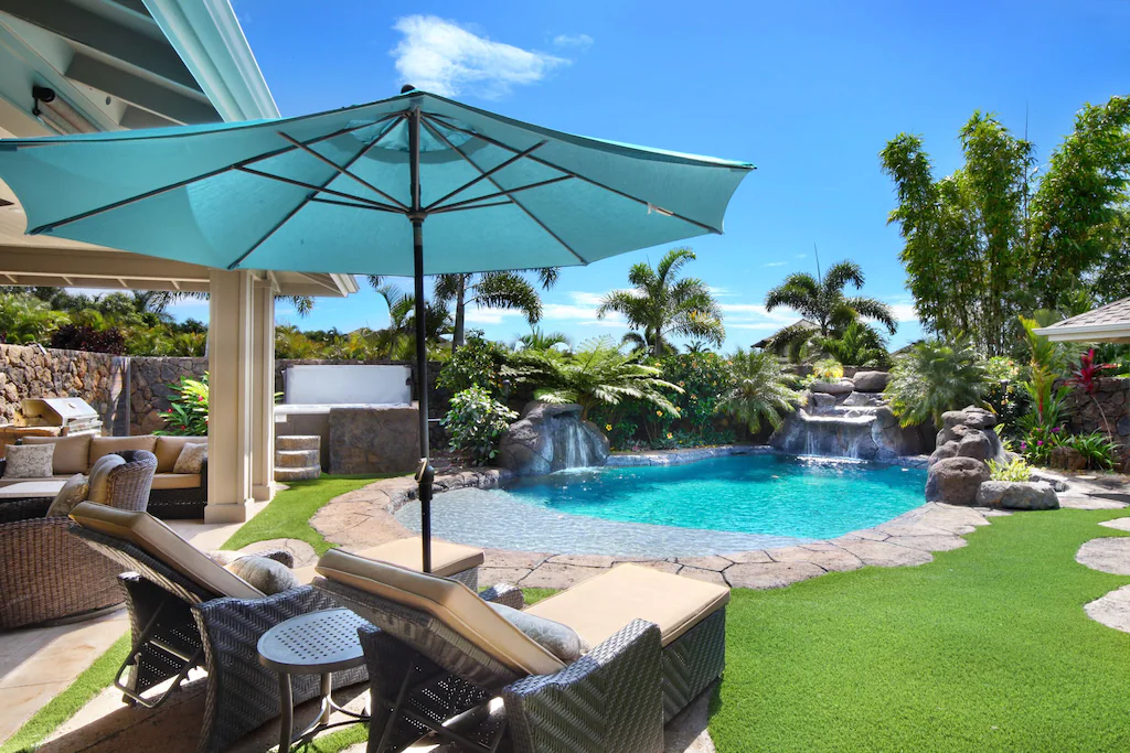 Image of a pool with two waterfalls and lounge chairs