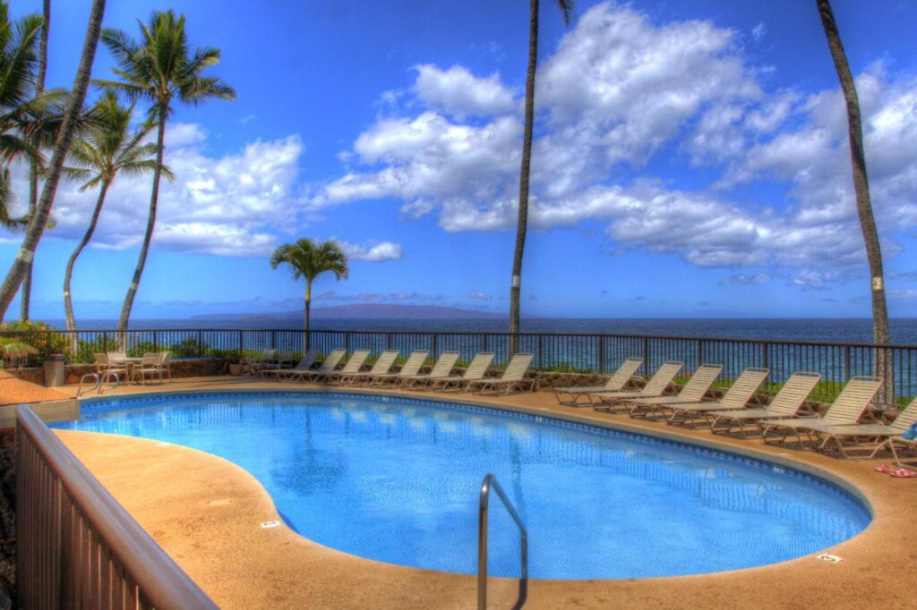 Image of a kidney-shaped pool next to the ocean