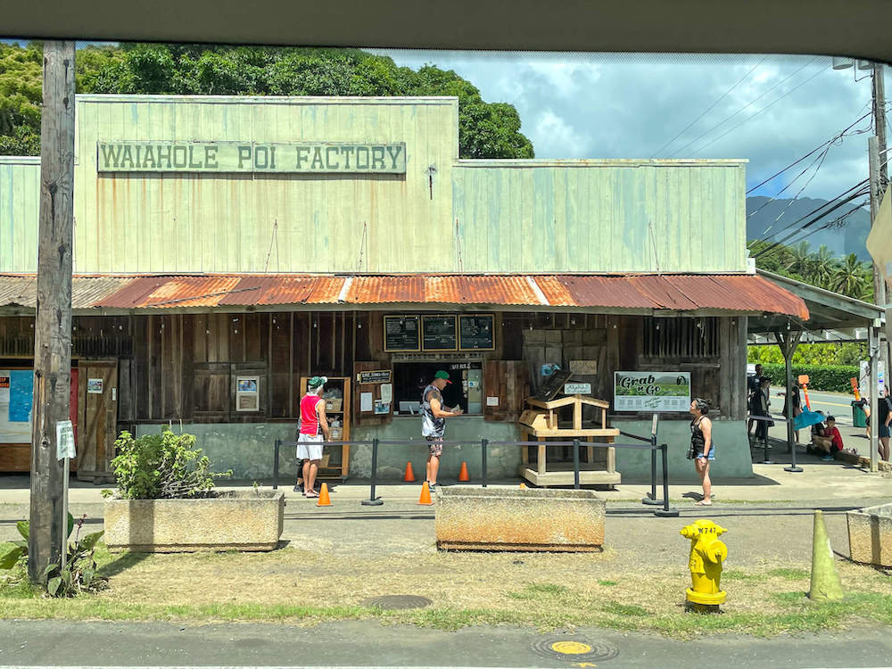 Image of a rusty green building with Waiahole Poi Factory sign on top