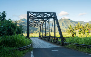 Find out all the ways to get around Kauai recommended by top Hawaii blog Hawaii Travel with Kids. Image of a metal bridge in Hanalei Kauai