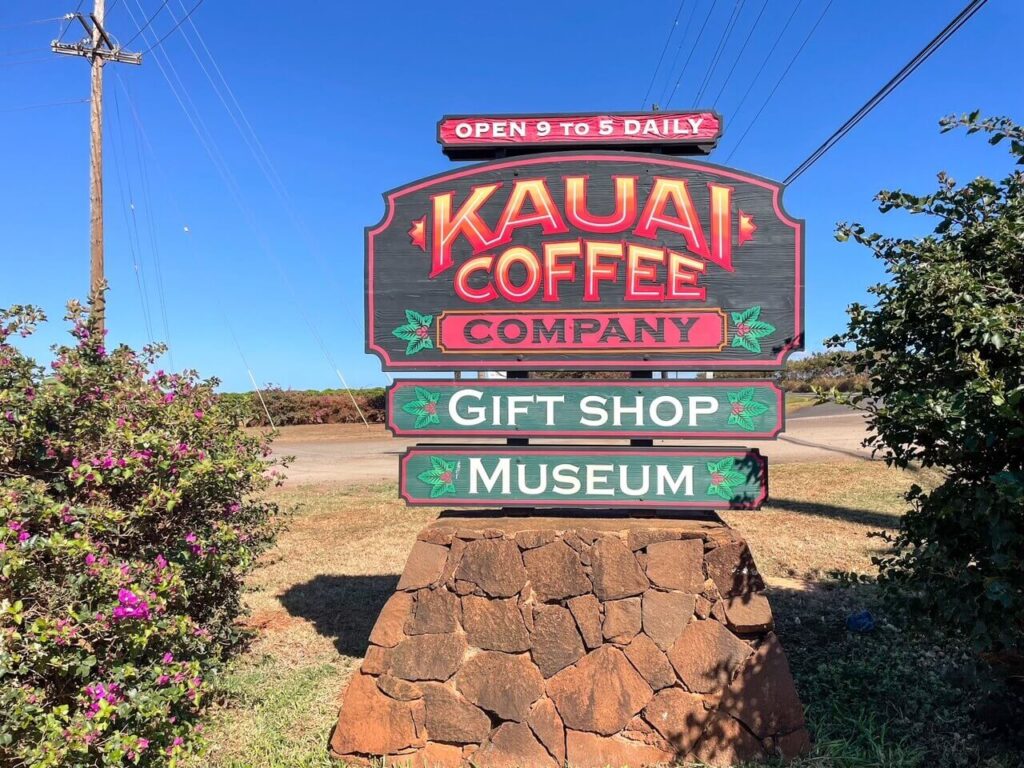 Check out this Kauai coffee tour review by top Hawaii blog Hawaii Travel with Kids! Image of the Kauai Coffee Company sign