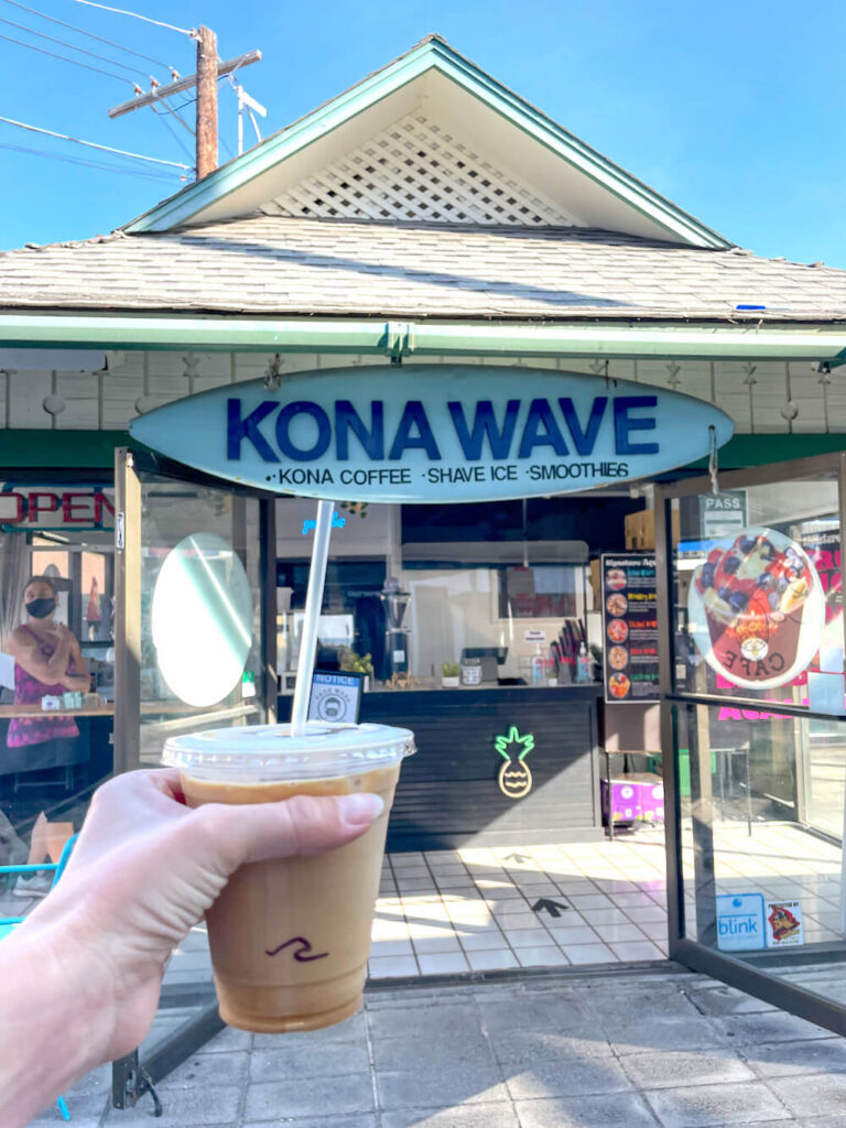 Image of an iced coffee in front of the Kona Wave cafe
