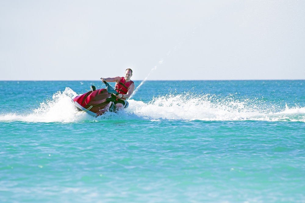 Image of a young man jet skiing