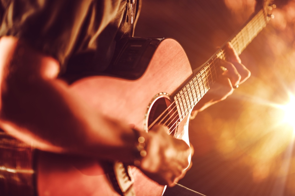 Acoustic Guitar Playing. Men Playing Acoustic Guitar Closeup Photography.