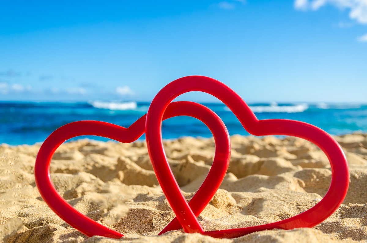 Find out the best things to do on Kauai in February recommended by top Hawaii blog Hawaii Travel Spot! Image of two hearts on the beach