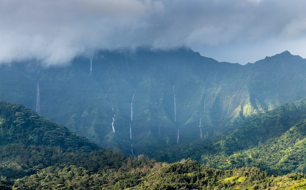 View over Na Pali range after a storm with cascading waterfalls near Hanalei, Kauai, Hawaii
