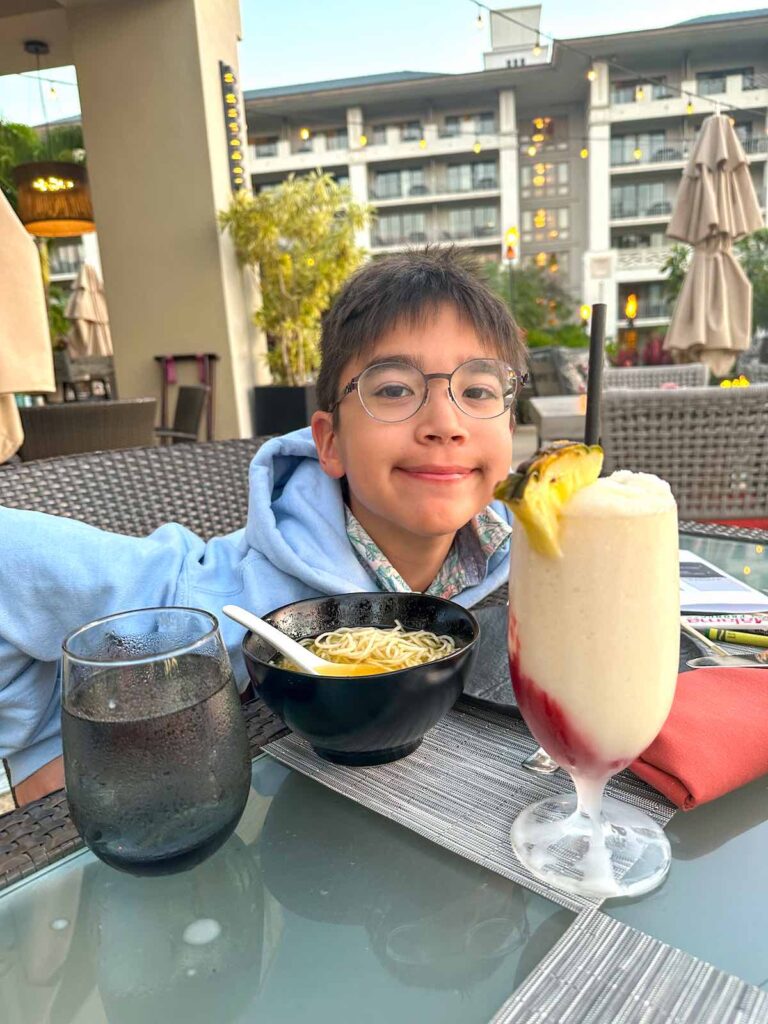 Image of a boy with a bowl of ramen and a lava flow drink