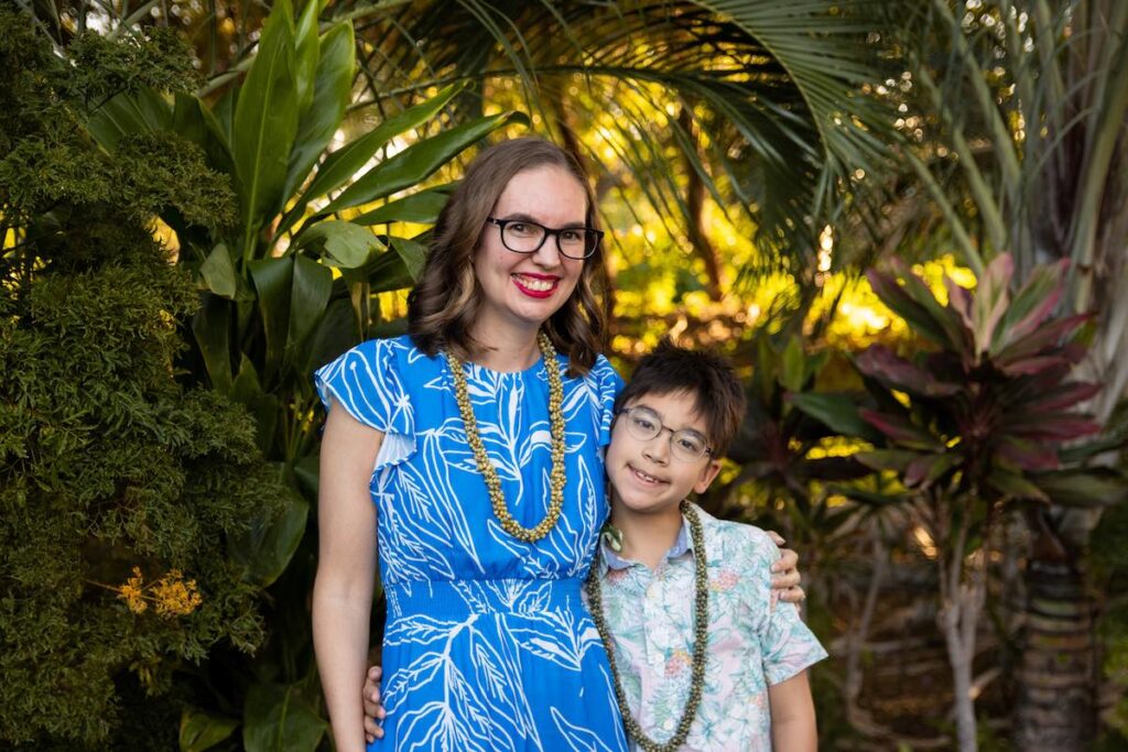 Image of a mom and son posing for a photo before the Fairmont Orchid Luau on the Big Island