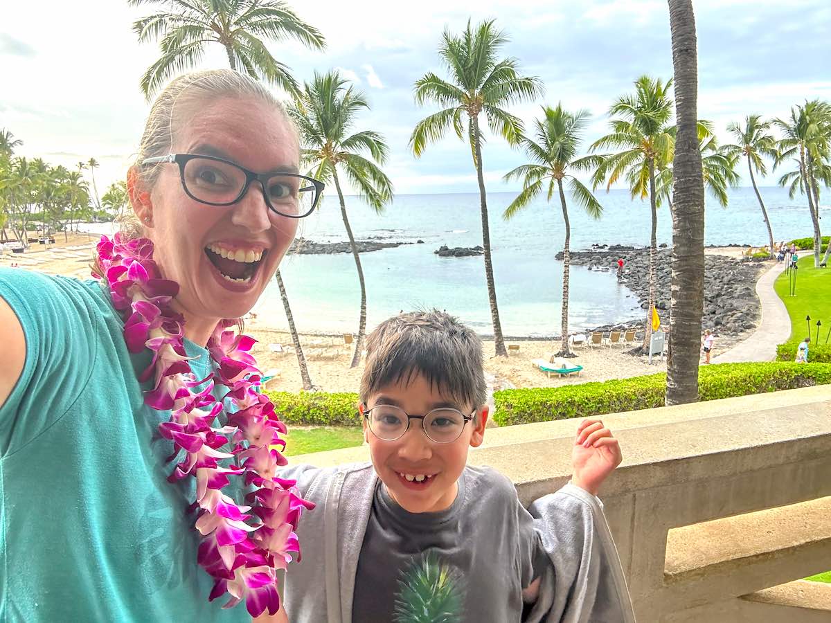 Check out this honest Fairmont Orchid review by top Hawaii blog Hawaii Travel with Kids. Image of a mom and son taking a selfie at a Big Island resort.