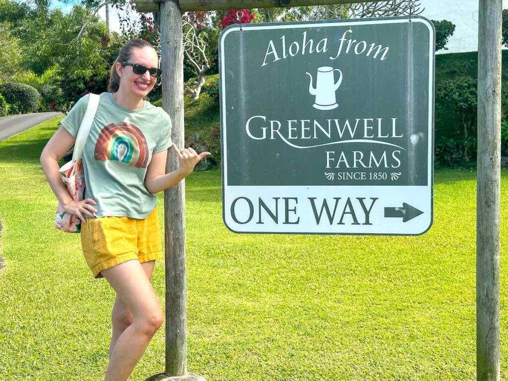 Image of a lady posing with the Greenwell Farms sign.