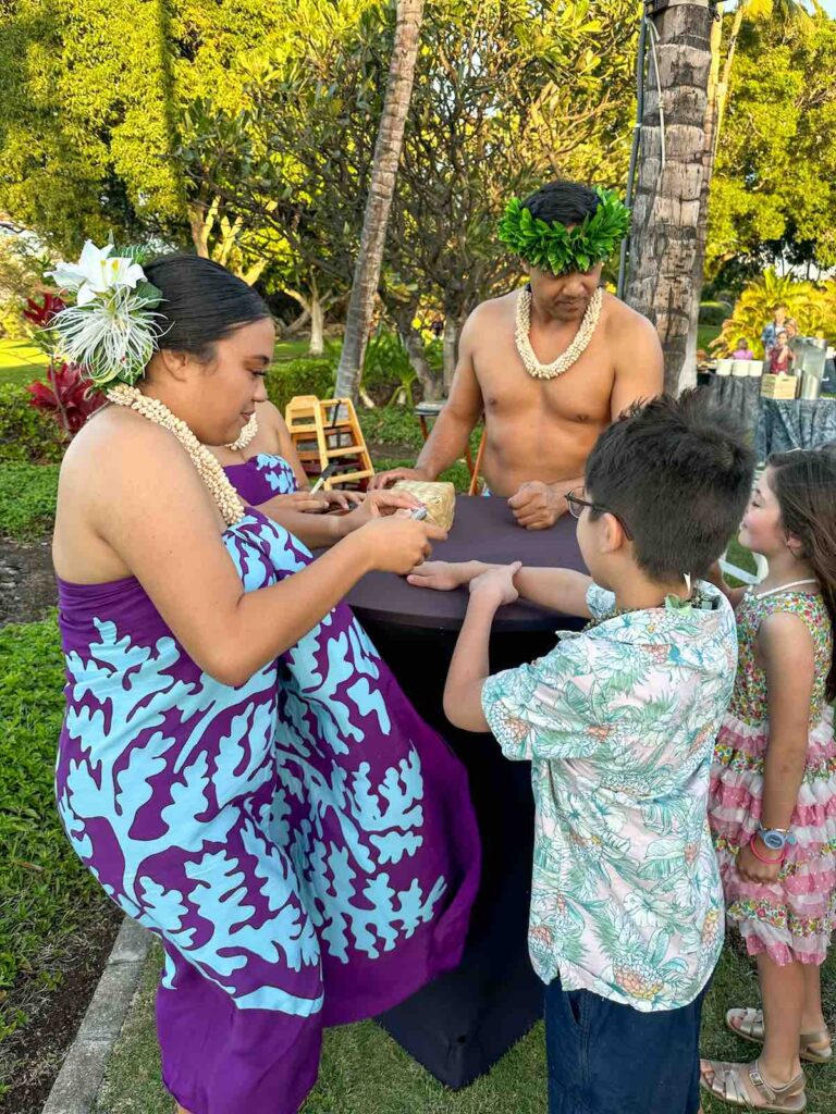 Image of a boy getting a temporary tattoo at a luau in Hawaii
