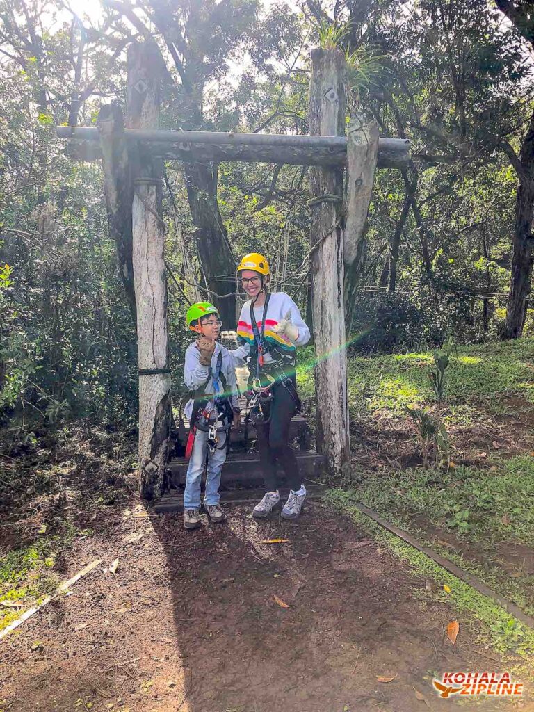 Image of a mom and boy in front of Kohala Zipline on the Big Island