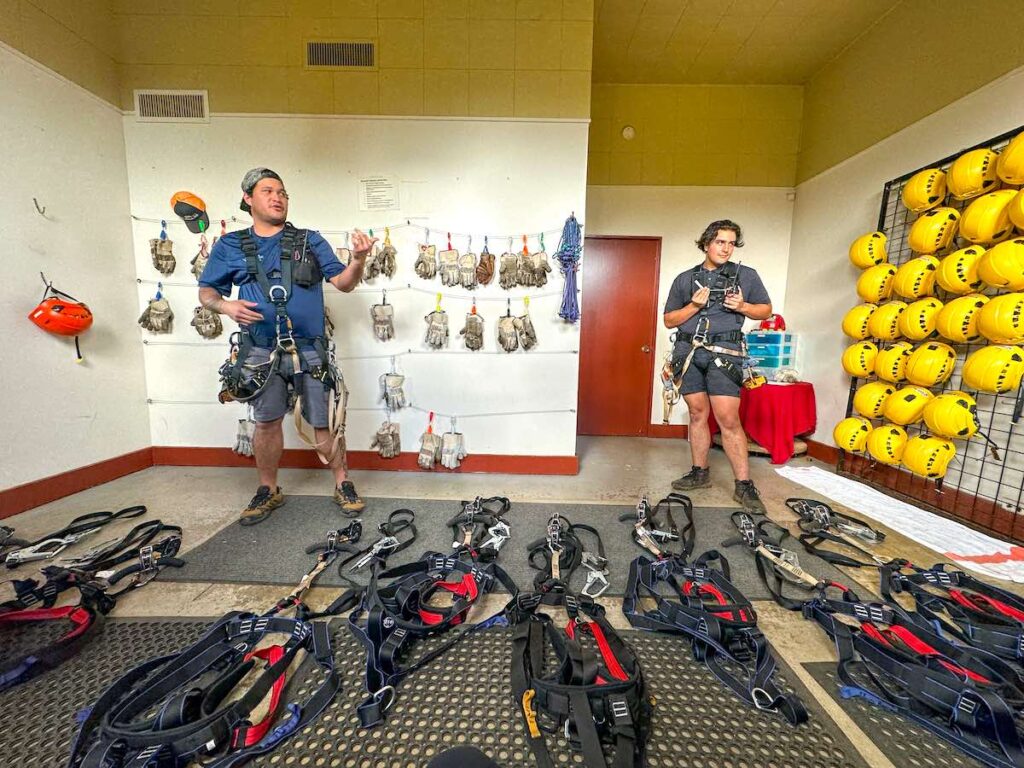 Image of two tour guides and a bunch of ziplining equipment