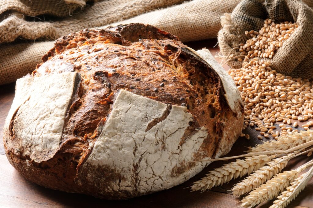 Freshly baked traditional bread on wooden table