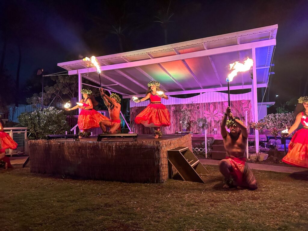 Image of hula dancers holding torches and lit coconuts at the Diamond Head Luau in Waikiki. Photo credit: Marcie Cheung