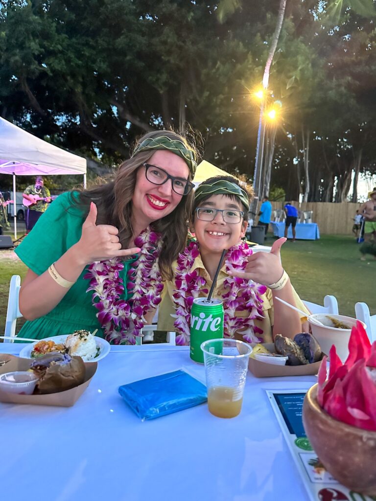 Marcie Cheung of Hawaii Travel with Kids and her son at the Diamond Head Luau in Waikiki.