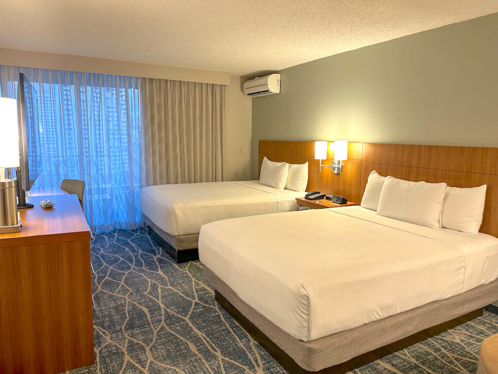 Image of two queen beds inside a room at the Hyatt Place Waikiki Beach. Photo credit: Marcie Cheung